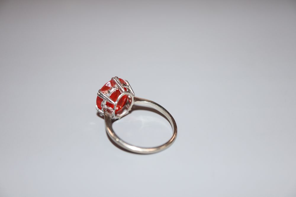 A 9ct white metal and oval cut fire opal? set dress ring, size N, gross 2.9 grams.